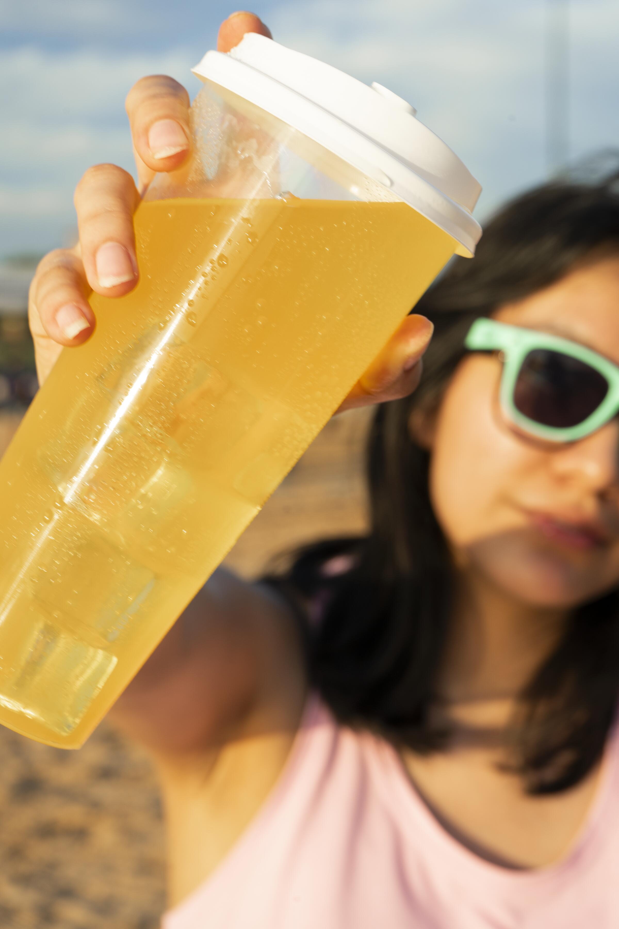 Girl holding yellow cup